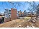 Large backyard features a brick chimney, deck, patio, and tiered stone planter at 7746 S Harrison Cir, Centennial, CO 80122