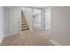 Finished basement space with neutral carpeting, white trim, and access to the upper levels at 7746 S Harrison Cir, Centennial, CO 80122