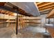 Unfinished basement utility room featuring exposed mechanicals, wooden shelving, and concrete floor at 7746 S Harrison Cir, Centennial, CO 80122