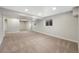 Expansive basement featuring carpet flooring, and neutral colored walls, and bright windows at 7746 S Harrison Cir, Centennial, CO 80122