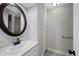 The bathroom features an updated vanity, large mirror, and stylish fixtures at 7746 S Harrison Cir, Centennial, CO 80122