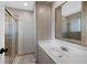 Bathroom with tile flooring and shower, modern vanity and mirror at 7746 S Harrison Cir, Centennial, CO 80122
