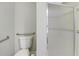 Bathroom with safety bars, shower stall, and decorative tile at 7746 S Harrison Cir, Centennial, CO 80122