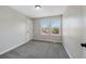 Carpeted bedroom with neutral paint, two windows, and white trim at 7746 S Harrison Cir, Centennial, CO 80122