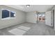 Bedroom with gray carpet, neutral paint, and a door leading to a small patio at 7746 S Harrison Cir, Centennial, CO 80122