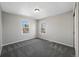 Carpeted bedroom with two windows and neutral paint color at 7746 S Harrison Cir, Centennial, CO 80122