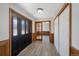 Bright entryway with new flooring, sliding door closets and glass accented French doors at 7746 S Harrison Cir, Centennial, CO 80122
