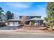 Charming two-story home with brick accents, two-car garage, and well-manicured front yard at 7746 S Harrison Cir, Centennial, CO 80122