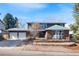 Charming two-story home with brick accents, a two-car garage, and a well-maintained front yard at 7746 S Harrison Cir, Centennial, CO 80122