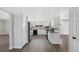 Bright kitchen with white cabinets, stainless steel appliances, and wood-look floors at 7746 S Harrison Cir, Centennial, CO 80122