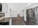 Updated kitchen with stainless steel refrigerator, updated flooring, and modern finishes at 7746 S Harrison Cir, Centennial, CO 80122