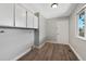 Functional laundry room offers additional cabinet space and a window for natural light at 7746 S Harrison Cir, Centennial, CO 80122