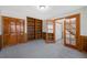 The home's living space boasts carpeted floors, a bookcase, and wood-trimmed windows at 7746 S Harrison Cir, Centennial, CO 80122
