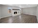Open living room featuring a brick fireplace with a wood beam and lots of natural light at 7746 S Harrison Cir, Centennial, CO 80122