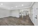 Bright, open-concept living room featuring stylish flooring and access to other living spaces at 7746 S Harrison Cir, Centennial, CO 80122