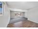 Open-concept living space showcasing hardwood floors, carpet, and a large window at 7746 S Harrison Cir, Centennial, CO 80122