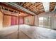 Unfinished basement with exposed ceiling and sliding glass door at 5395 Canyon View Dr, Castle Rock, CO 80104