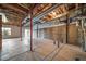 Unfinished basement featuring a concrete floor, exposed ceiling, and natural light at 5395 Canyon View Dr, Castle Rock, CO 80104