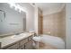 Bathroom with a tiled tub, toilet, and sink with vanity at 5395 Canyon View Dr, Castle Rock, CO 80104