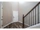 Inviting entryway with wood-look flooring and staircase with black iron railing at 5395 Canyon View Dr, Castle Rock, CO 80104