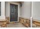 Close-up of a stylish front door with stone accents and modern lighting at 5395 Canyon View Dr, Castle Rock, CO 80104