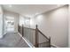 Hallway with carpet flooring, featuring iron railing and a window view at 5395 Canyon View Dr, Castle Rock, CO 80104