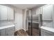 Modern kitchen featuring gray cabinets, stainless steel refrigerator, stylish tile backsplash and wood flooring at 5395 Canyon View Dr, Castle Rock, CO 80104