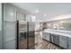 Open kitchen view with stainless steel appliances, gray cabinets, and a view of the living room at 5395 Canyon View Dr, Castle Rock, CO 80104