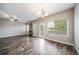 Spacious living room with a fireplace, large windows, stylish floors, and a ceiling fan at 5395 Canyon View Dr, Castle Rock, CO 80104