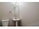 A clean and modern powder room featuring a pedestal sink and neutral decor at 5395 Canyon View Dr, Castle Rock, CO 80104