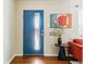 Modern entryway with a vibrant blue door, sleek console table, and stylish artwork that enhance the home's appeal at 3605 E 29Th Ave, Denver, CO 80205