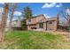 View of the home's backyard featuring a well-manicured lawn, patio, and mature trees, creating a private outdoor space at 5307 E Courtney Ave, Castle Rock, CO 80104