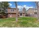 Lush backyard showcasing the home's exterior, including a sliding glass door leading to a cozy patio area and green lawn at 5307 E Courtney Ave, Castle Rock, CO 80104