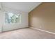 Spacious carpeted bedroom bathed in natural light with a large window, offering a tranquil and inviting atmosphere at 5307 E Courtney Ave, Castle Rock, CO 80104