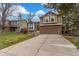 A charming home with brick and wood siding and a concrete driveway offers curb appeal and functionality at 5307 E Courtney Ave, Castle Rock, CO 80104
