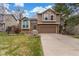Charming two-story home with a well-manicured lawn, attached garage, and inviting facade, creating a welcoming curb appeal at 5307 E Courtney Ave, Castle Rock, CO 80104