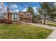 Attractive exterior of this home with its brick and wood siding, complemented by a lush lawn and mature trees at 5307 E Courtney Ave, Castle Rock, CO 80104