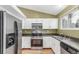 Well-equipped kitchen with modern appliances and white cabinetry, offering a clean and functional space at 5307 E Courtney Ave, Castle Rock, CO 80104