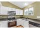 Efficient kitchen with stainless steel appliances, white cabinets, and natural light, ideal for cooking at 5307 E Courtney Ave, Castle Rock, CO 80104