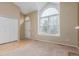 Bright living room featuring large arched window, plush carpet, and adjacent closet space at 5307 E Courtney Ave, Castle Rock, CO 80104