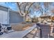 Landscaped backyard with seating area, gazebo, mature tree, and well-maintained lawn at 3270 S Galapago St, Englewood, CO 80110