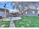 Lush backyard with a trampoline, shed, mature tree, string lights, and a patio area for outdoor enjoyment at 3270 S Galapago St, Englewood, CO 80110