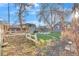 Large backyard with green grass, mature trees, a storage shed, and outdoor equipment at 3270 S Galapago St, Englewood, CO 80110