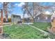 Well-maintained backyard featuring lush green grass, a storage shed, and mature trees at 3270 S Galapago St, Englewood, CO 80110
