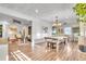 Bright dining area adjacent to the living room with hardwood floors and modern lighting at 3270 S Galapago St, Englewood, CO 80110