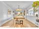 Bright dining area featuring a rustic wooden table and benches, adjacent to the living space at 3270 S Galapago St, Englewood, CO 80110