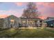 Charming single-story home featuring a cozy front porch and well-maintained lawn at twilight at 3270 S Galapago St, Englewood, CO 80110