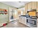 Bright kitchen featuring stainless steel appliances, tile flooring, and sliding glass door to patio at 3270 S Galapago St, Englewood, CO 80110