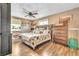 Cozy bedroom featuring hardwood floors, a ceiling fan, and a large comfy bed at 3270 S Galapago St, Englewood, CO 80110
