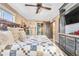 Comfortable bedroom with hardwood floors, ceiling fan, and a sliding barn door at 3270 S Galapago St, Englewood, CO 80110